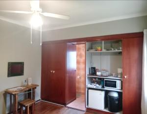 a living room with a kitchen with a microwave at Kliplelie Selfsorg in Tulbagh