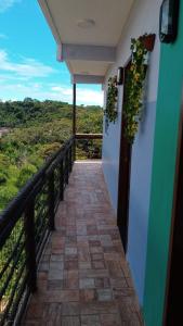 a balcony with a walkway with plants and a view at Paim`s Village Itacaré in Itacaré