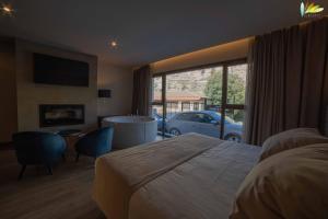 a bedroom with a bed and a view of a car at Almazara Suites in Alcalá del Júcar