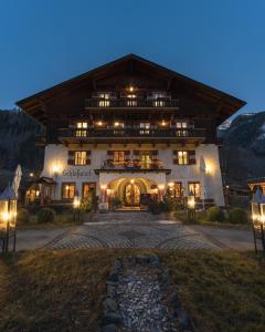 a large building with lights in front of it at Hotel Schlosswirt in Großkirchheim