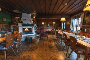 a restaurant with a fireplace and tables and chairs at Hotel Schlosswirt in Großkirchheim