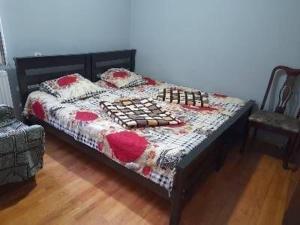 a bedroom with a bed with a quilt and pillows at Guest House Edem in Tbilisi City