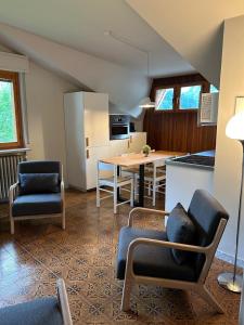 a kitchen and living room with a table and chairs at Il Faggio Rosso Apartment in Vernante +13 photos