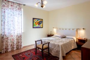 a bedroom with a bed and a chair and a window at Villa Marchetti in Cupra Marittima +50 photos