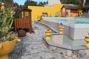 a swimming pool with a resort with cactusitures and a pool at Résidence SIMONA in Deshaies +29 photos