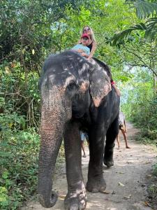 a woman riding on the back of an elephant at Villa Hide Out in Busse