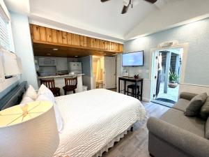 a bedroom with a large bed and a kitchen at Welcome Matt's - Truman @ Duval Unit B in Key West