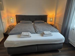 a bedroom with a bed with two pillows on it at Ferienwohnung Arminius in Detmold