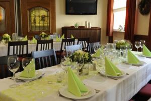 a table with green napkins and wine glasses on it at Gasthof Robens in Dormagen +30 photos