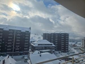 a view of a city with snow covered buildings at Sunny view in Zlatibor