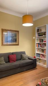 a living room with a couch and a book shelf at Paradise Suites - Brignole Station - Best Price Rooms - ALWAYS OPEN in Genoa +46 photos