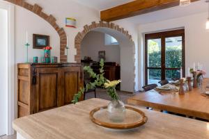 a kitchen and dining room with a table and an archway at Villa Marchetti in Cupra Marittima