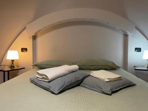 a large bed with two pillows on top of it at Paradise Suites - Brignole Station - Best Price Rooms - ALWAYS OPEN in Genoa
