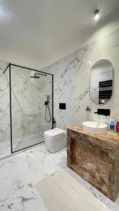 a white bathroom with a sink and a shower at Paradise Suites - Brignole Station - Best Price Rooms - ALWAYS OPEN in Genoa