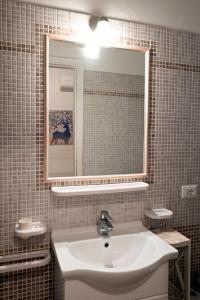 a bathroom with a sink and a mirror at Hotel Torre in Viareggio +7 photos