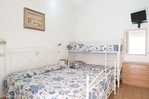 a bedroom with two bunk beds and a tv at Hotel Torre in Viareggio