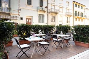 a group of tables and chairs on a patio at Hotel Torre in Viareggio