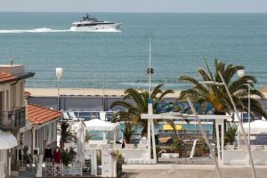a cruise ship in the ocean with a beach at Hotel Torre in Viareggio