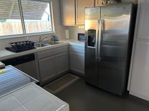 a kitchen with a stainless steel refrigerator and a sink at Turlocks Little Palace in Turlock