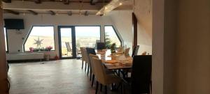 a dining room with a long table and chairs at Restful Haven in Icafalău