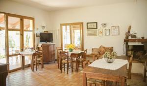 a living room with tables and chairs and a television at Pian del Pigro in Rimini