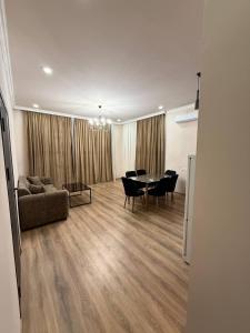 a living room with a table and chairs and a couch at Elen Apartment Goris in Goris