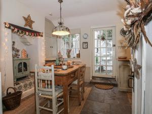 a dining room with a table and a fireplace at 8 Welsh Street in Bishops Castle
