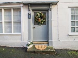 a door of a house with a wreath on it at 8 Welsh Street in Bishops Castle