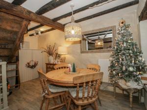 a dining room with a table and a christmas tree at 8 Welsh Street in Bishops Castle +19 photos