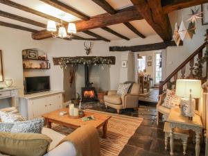 a living room filled with furniture and a fireplace at 8 Welsh Street in Bishops Castle