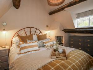 a bedroom with a large bed with a wooden headboard at 8 Welsh Street in Bishops Castle
