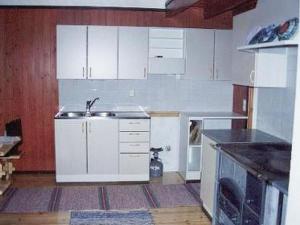 a kitchen with white cabinets and a sink at Holiday Home 6332 by Interhome in Rantakylä