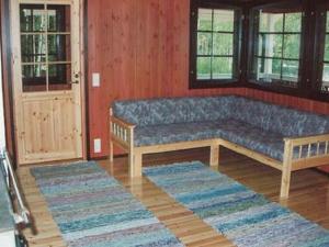 a couch in a living room with two rugs at Holiday Home 6332 by Interhome in Rantakylä