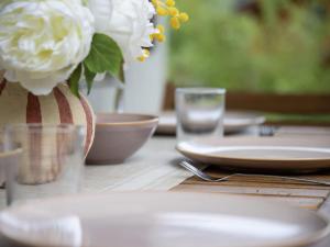 a wooden table with a vase with white flowers in it at Chalet Le Katanga by Interhome in Ovronnaz