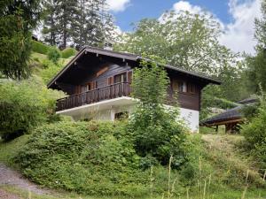 a wooden house with a balcony on a hill at Chalet Le Katanga by Interhome in Ovronnaz