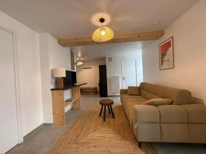a living room with a couch and a table at Escale à Boisinges in Viuz-en-Sallaz