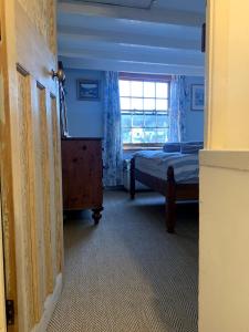 a bedroom with two beds and a window at Fisherman's Cottage, Staithes in Staithes