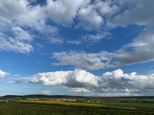 a green field with a blue sky with clouds at Fisherman's Cottage, Staithes in Staithes +57 photos