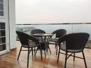 a group of chairs and a table on a balcony at Devs Villa Amansara above the sky in Pune