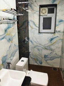 a bathroom with a white toilet and a sink at Devs Villa Amansara above the sky in Pune +24 photos