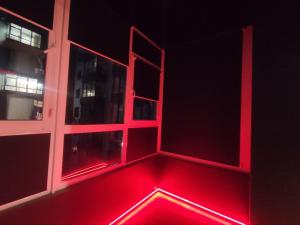 an empty room with red lights on a window at RED Тематичні Апартаменти in Zhytomyr