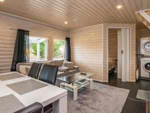 a living room with a couch and a table at Holiday Home Koskiharju by Interhome in Säynetlahti +21 photos