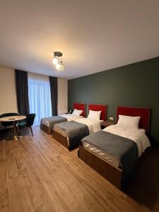 a hotel room with two beds and a table at Gоderdzi Twins Hotel in Goderdzi +41 photos