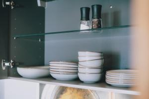 a shelf with plates and bowls on it at Mooslodge in Kaprun +17 photos