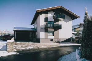 a building next to a body of water at Mooslodge in Kaprun