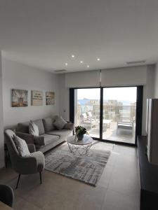 a living room with a couch and a table at Sunset Cliffs Luxury Apartment Benidorm in Benidorm +37 photos