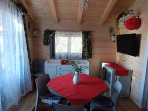 a dining room with a red table and chairs at Etna Baite Milo in Milo