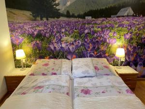 two beds in front of a field of flowers at Domek pod Maciejową in Rabka-Zdrój