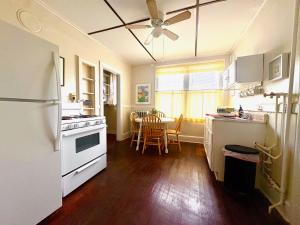 a kitchen with white appliances and a table with chairs at The Wadsworth Suite A2 in Hartford