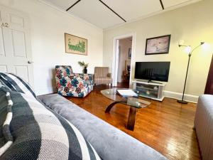 a living room with a couch and a table at The Wadsworth Suite A2 in Hartford